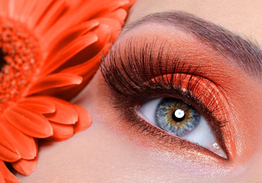 false eyelashes and fashion eye make-up with  orange flower